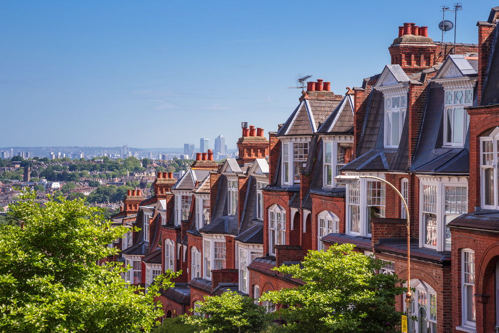 A row of terraced houses overlooks a view of London